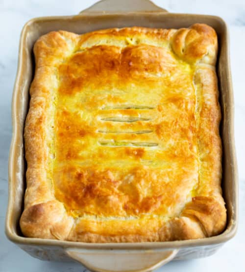 A casserole with golden brown puff pastry . 