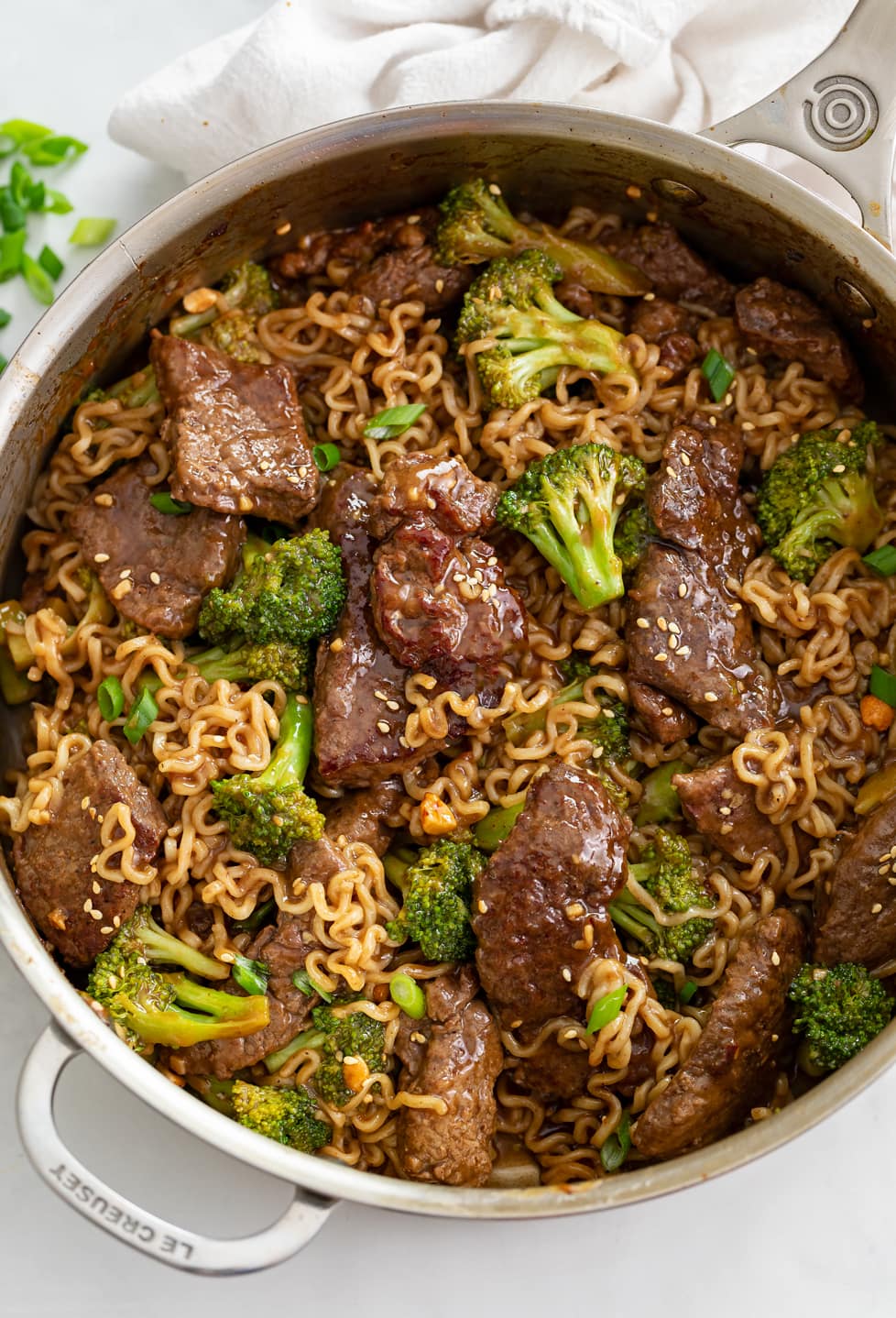 Beef and Broccoli Ramen in a skillet with brown sauce.