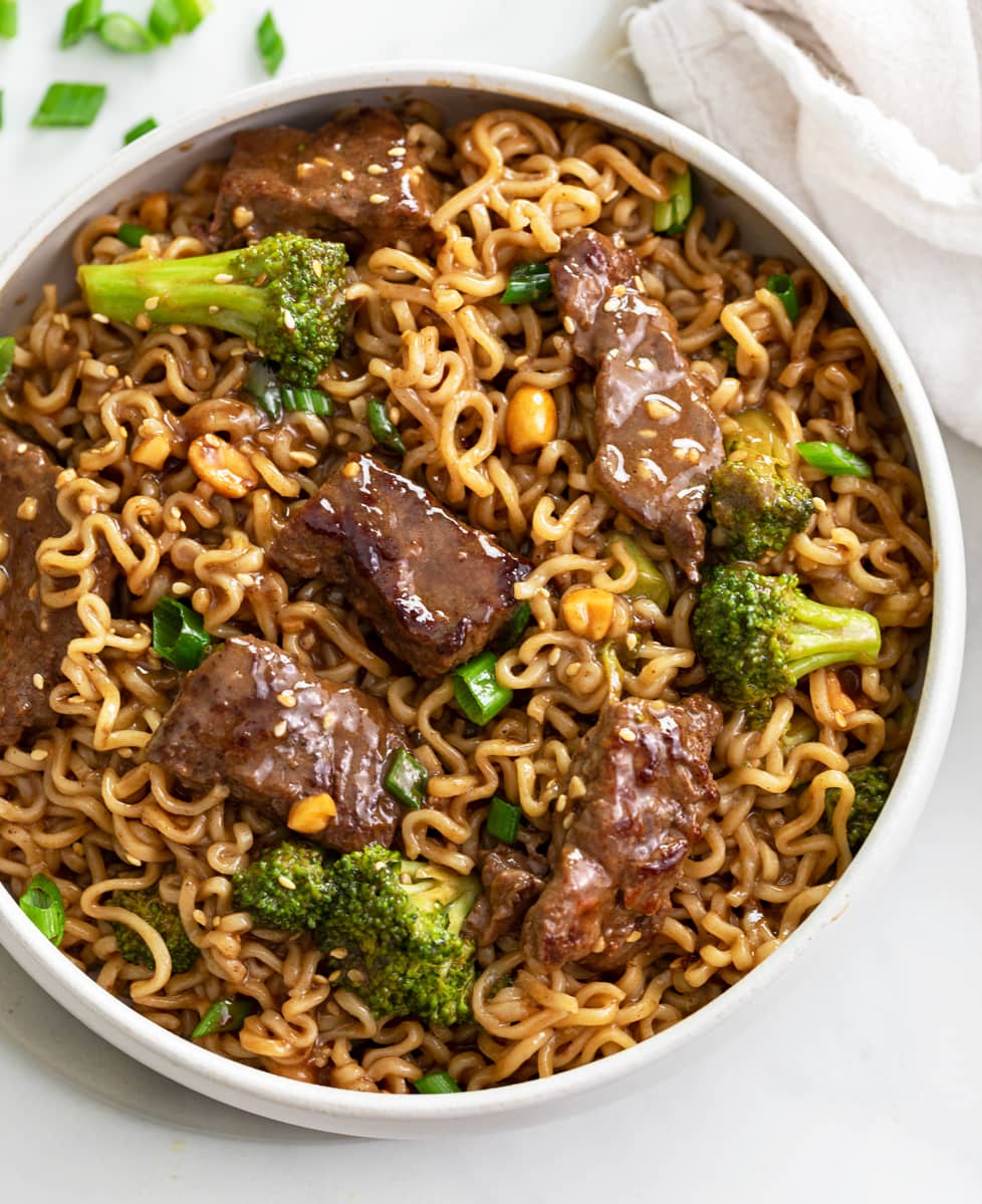 A bowl of Ramen Noodles with Beef and Broccoli on top.