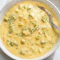 Broccoli Cheese Soup in a bowl with a spoon in it.