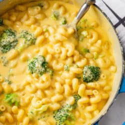 A large saucepan filled with creamy broccoli mac and cheese.