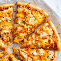 Slices of Buffalo Chicken Pizza with blue cheese and buffalo sauce.