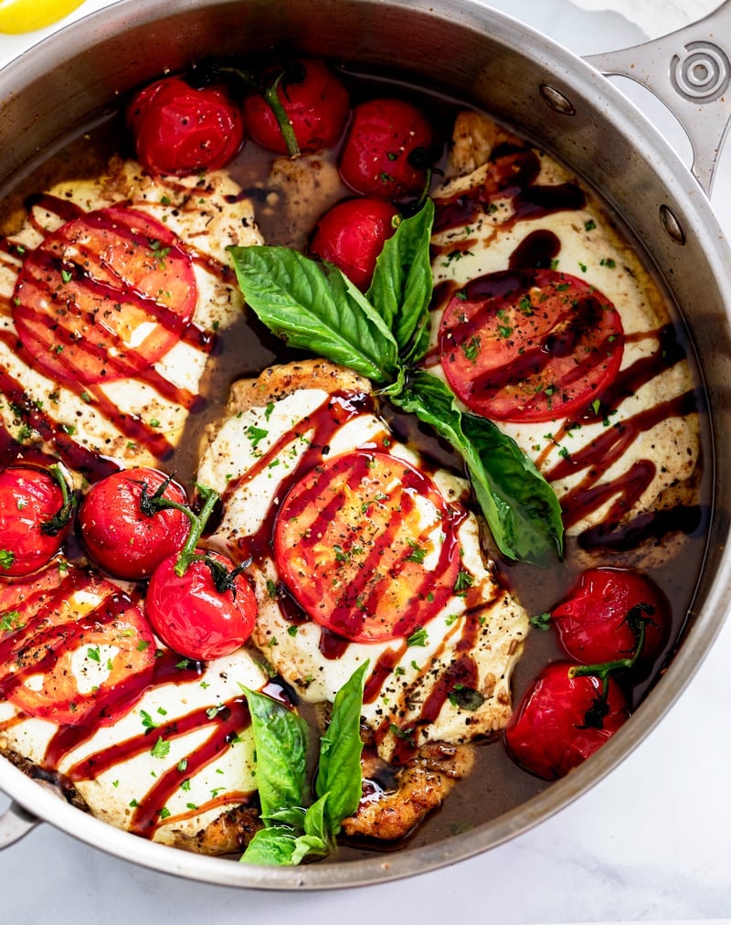 Caprese Chicken in a Skillet with Balsamic Sauce, Tomatoes, Basil, and Balsamic Glaze.