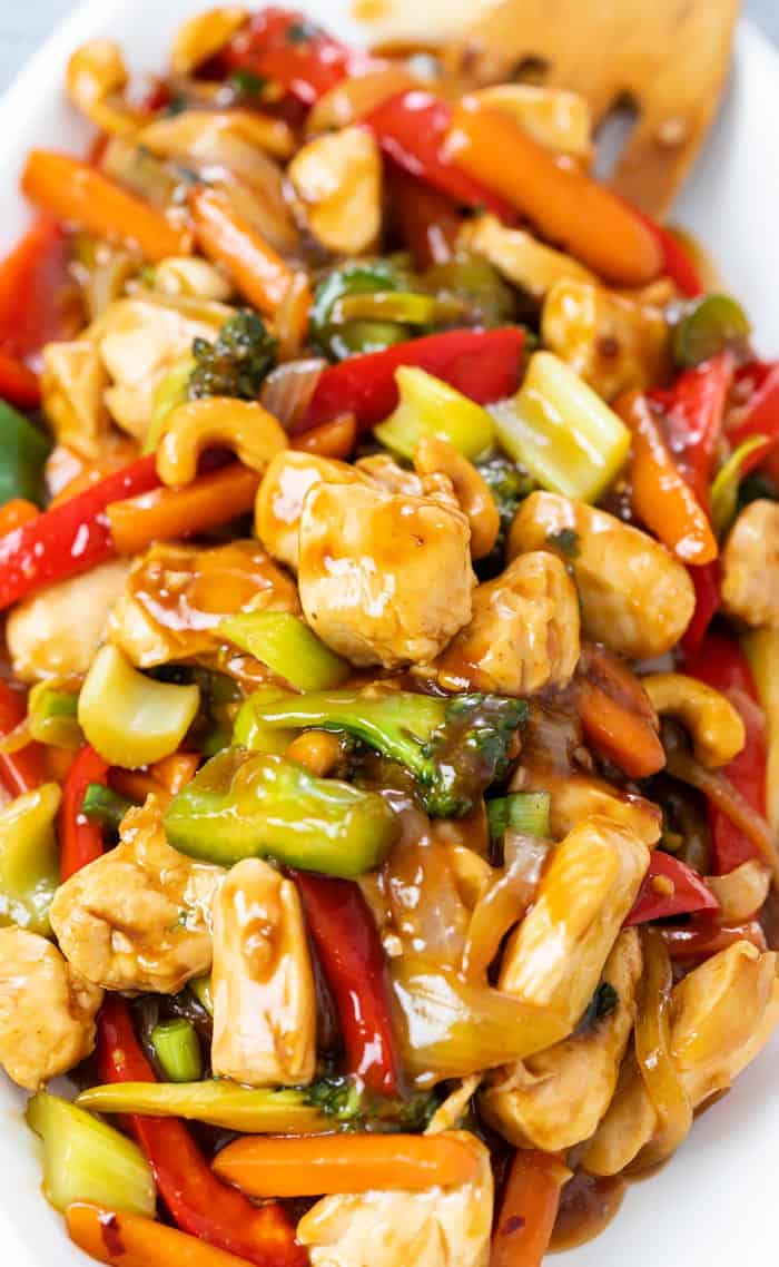 A close up view of chicken stir fry with vegetables and sauce.
