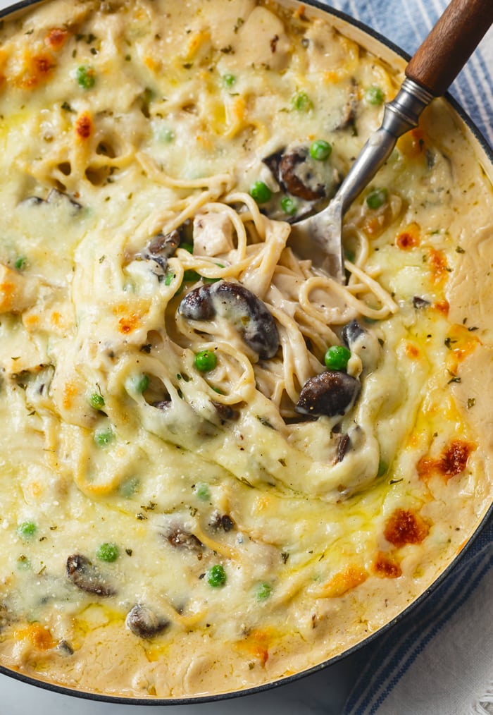 A found skillet with creamy Chicken Tetrazzini with mushrooms and peas.