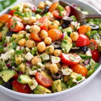 Chickpea Salad with feta cheese, dressing, and vegetables.