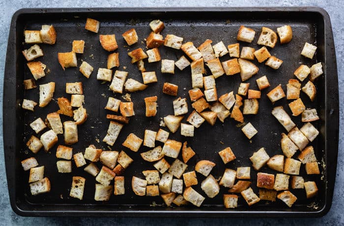 cubes of bread on a baking sheet after being baked for homemade croutons.