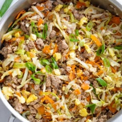 A skillet filled with Egg Roll in a Bowl with cabbage, carrots, pork, and scrambled eggs.
