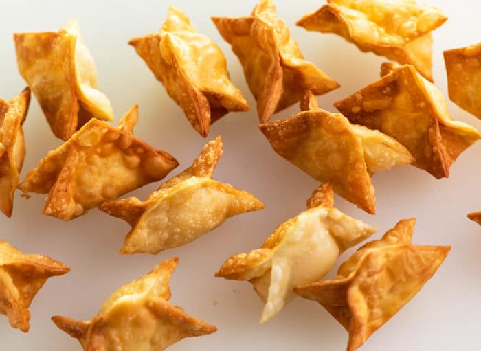 overhead shot of fried crab rangoon on a white background