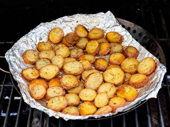 Roasted potatoes on foil on the grill.