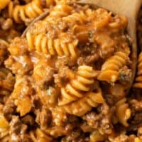 A wooden spoon full of creamy Ground Beef Pasta.