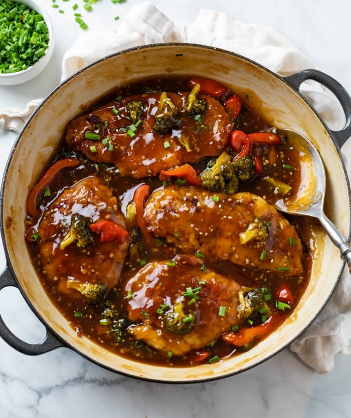 A skillet filled with Honey Garlic Chicken with Glaze, Broccoli, and Peppers.