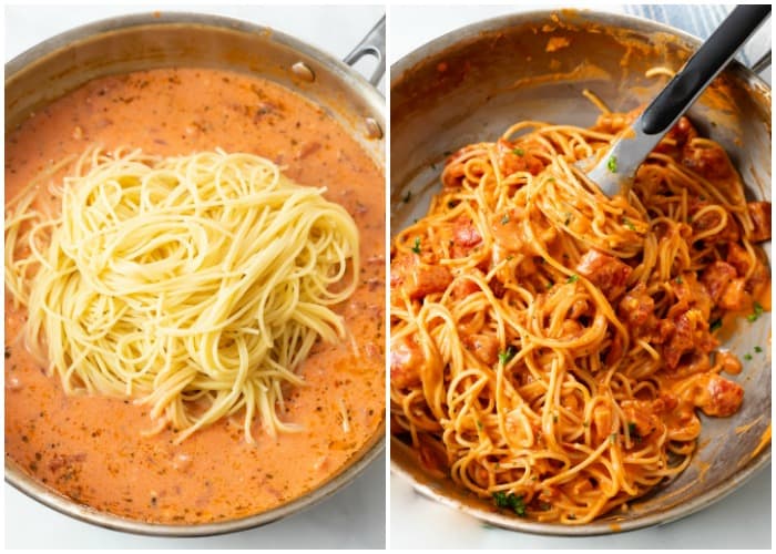 Adding spaghetti to a cream sauce for creamy tomato pasta.