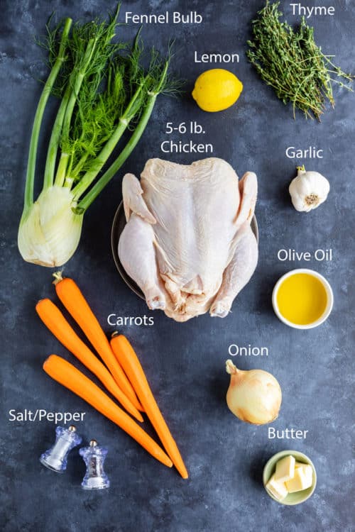 Ingredients needed to make roast chicken lying on a blue surface.