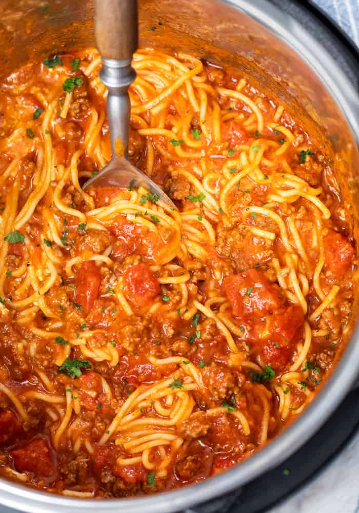 An Instant Pot filled with Spaghetti in marinara sauce with ground beef and diced tomatoes.