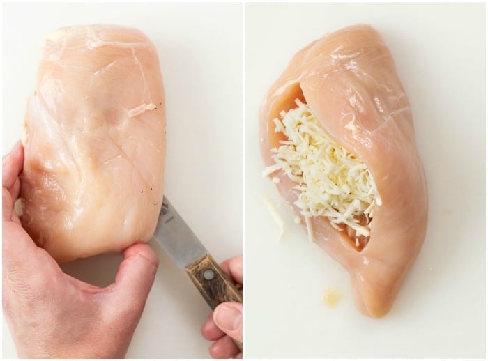 A hand cutting a slice in a chicken breast to create a pocket to stuff mozzarella cheese inside.
