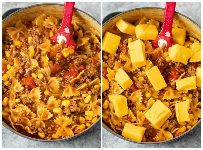 Cooked pasta noodles in sloppy joe sauce with cheese being added to make sloppy joe casserole
