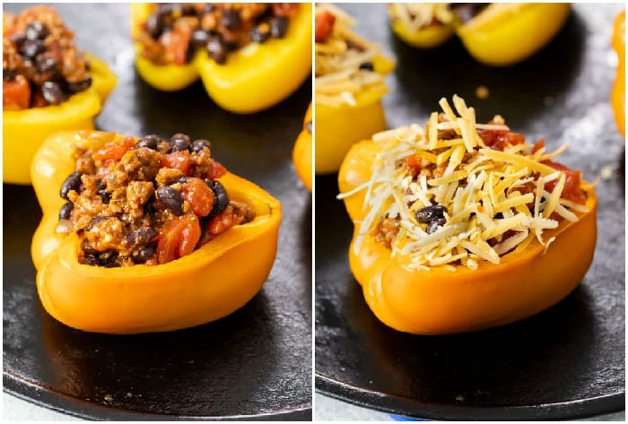 Bell peppers on a baking sheet filled with taco filling and topped with shredded cheese.
