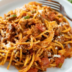 A white plate topped with One Pot Spaghetti in meat sauce.