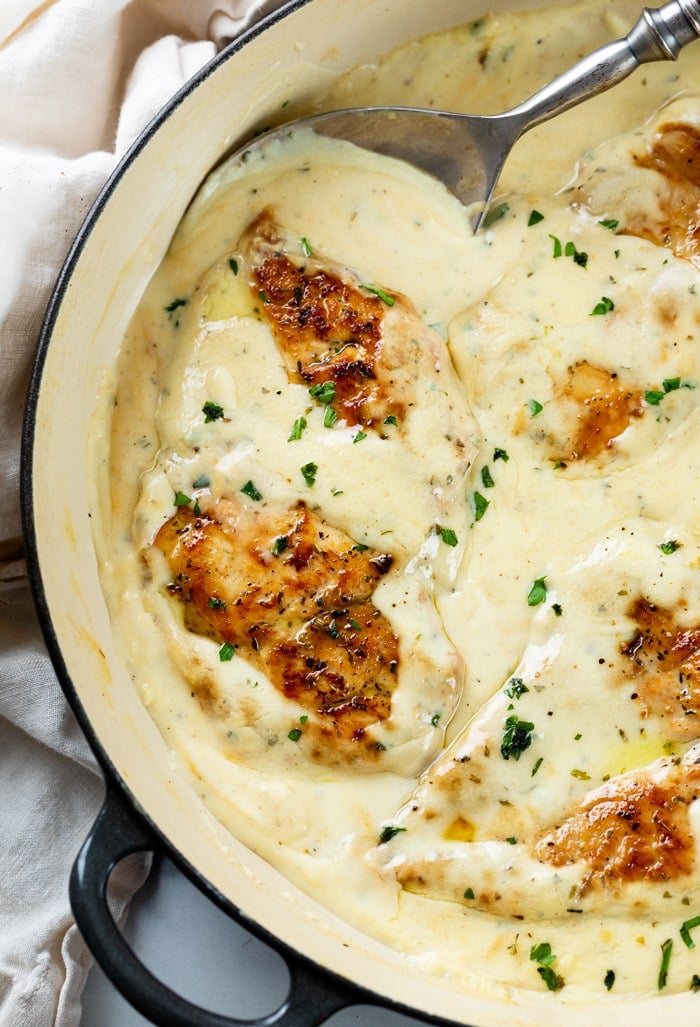 A skillet with Creamy Ranch Chicken topped with parsley.
