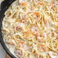 A skillet of Shrimp Alfredo with Fettucine pasta.