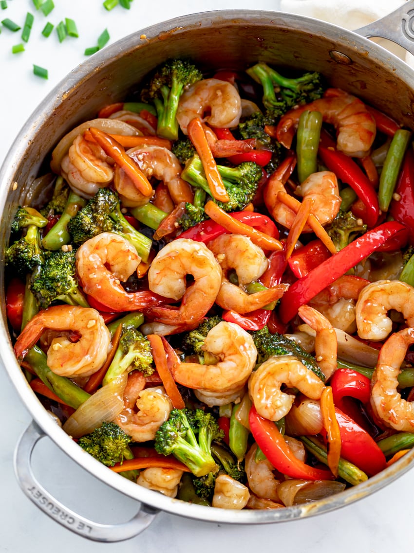A skillet filled with Shrimp Stir Fry in a brown sauce with vegetables.