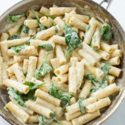 A silver skillet filled with Creamy Broccoli Pasta in a Garlic Parmesan Sauce.