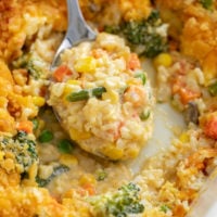 A spoon filled with creamy Vegetable Casserole.